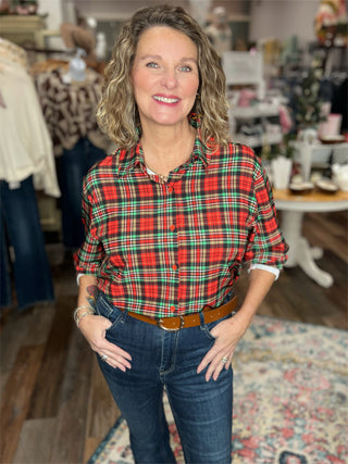 Woman wearing a red plaid shirt and jeans in a store setting
