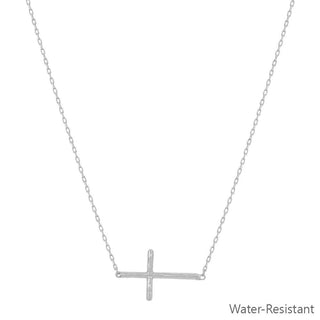 Silver cross necklace on a white background