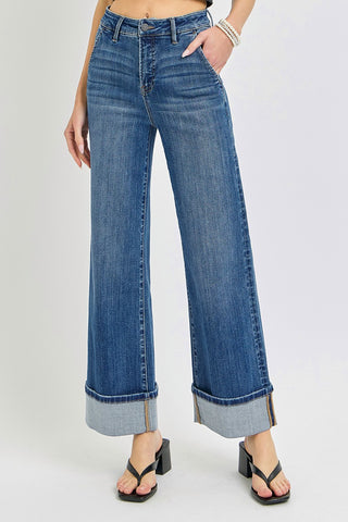 Person wearing blue jeans with a white background