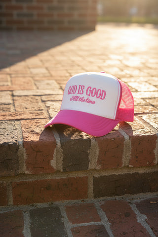 Pink and white cap with 'God is Good All the time' text on a white background
