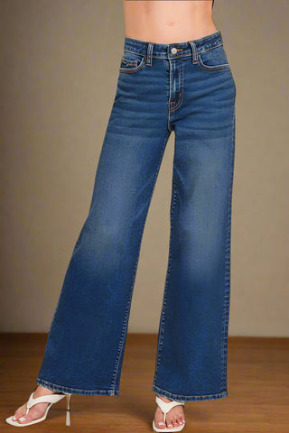 Dark blue flared jeans on a white background