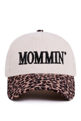 Cap with 'MOMMIN' text on a white background