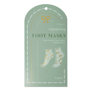 A mint green retail packaging card for SPA LIFE repairing foot masks, featuring gold foil accents, white dashed line borders, and an illustration of two socks with gold patterns.
