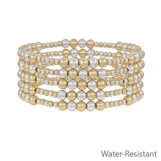 Set of gold and silver beaded bracelets on a white background
