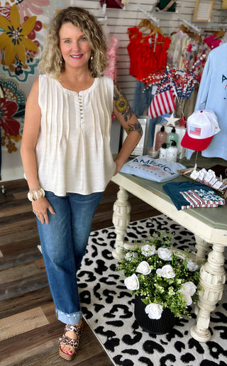 Woman standing in a store with clothing and decor around her