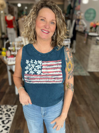 Woman wearing a tank top with an American flag design in a store setting