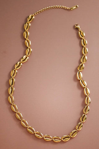Gold necklace on a brown background