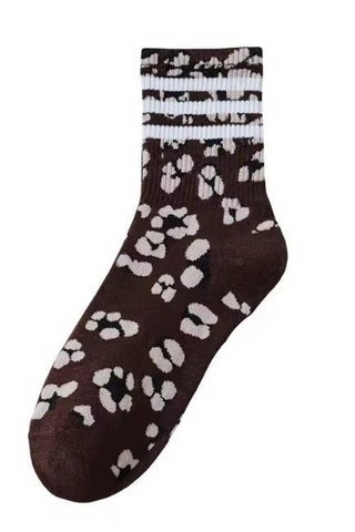 Brown sock with white paw print pattern on a white background