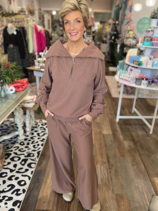 Woman wearing a brown outfit in a store setting