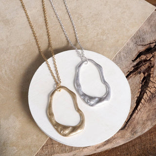 Gold and silver abstract shaped necklaces on long chains 