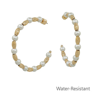 Gold hoop earrings with white faux pearls and textured gold oval beads, shown on a white background with 'Water-Resistant' text in the bottom right corner.