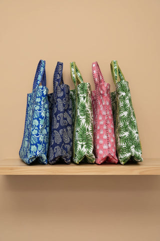 Colorful patterned bags arranged on a beige background