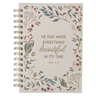 Notebook with floral design and Bible verse on a white background