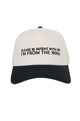 Beige and black cap with text 'Please be patient with me, I'm from the 1900s' on a white background