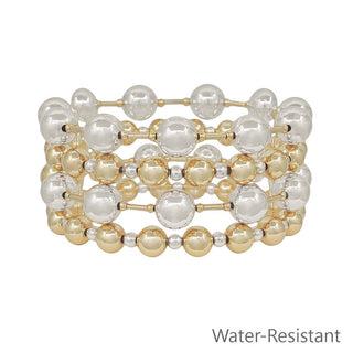 Stack of gold and silver beaded bracelets on a white background with 'Water-Resistant' text.