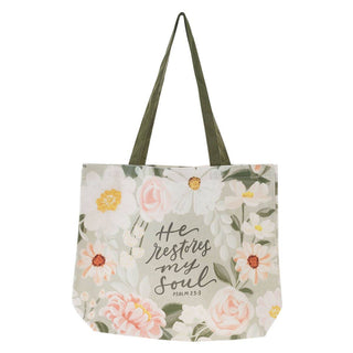 Floral tote bag with 'He restores my soul' text on a white background