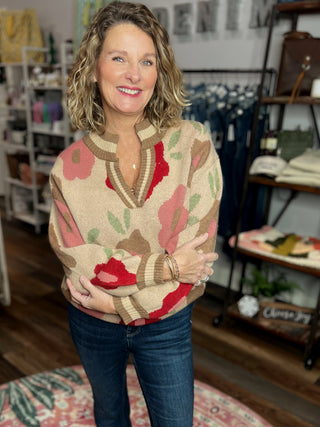 Woman wearing a patterned sweater in a store setting