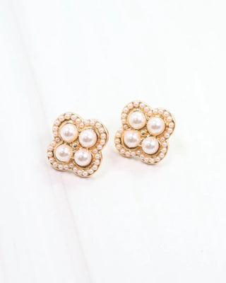 Heart-shaped earrings with pearl details on a white background