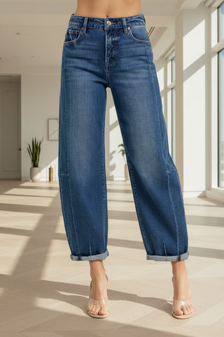 Blue jeans worn by a person on a light gray background