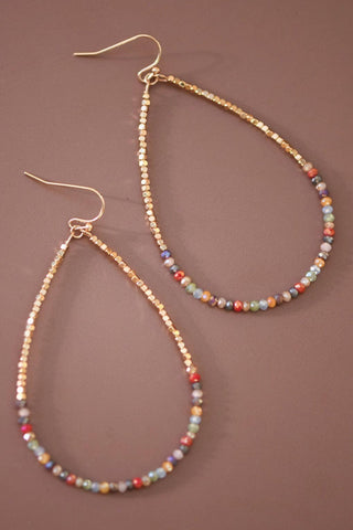 Beaded earrings on a brown background