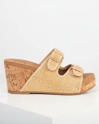 Beige wedge sandal with cork wedge sole on a white background