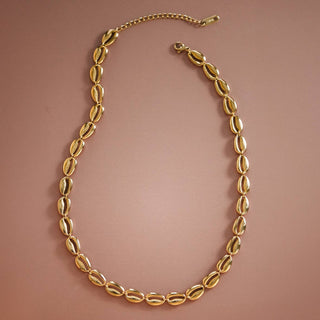 Gold necklace on a brown background