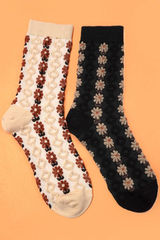 Two pairs of socks with floral patterns on a peach background