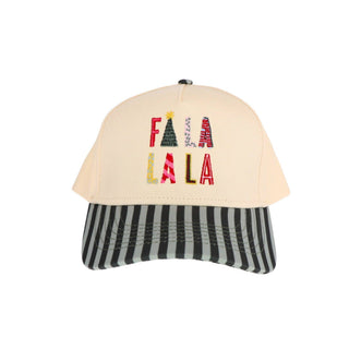 A baseball cap with a cream-colored crown and a black-and-white striped visor. The front of the crown features the word 'FALALA' embroidered in festive holiday-themed lettering.