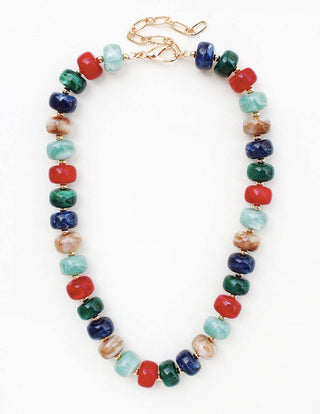 A beaded necklace with alternating marbled red, green, blue, and light blue beads, accented by gold-toned spacers and a gold lobster clasp, shown on a plain white background.