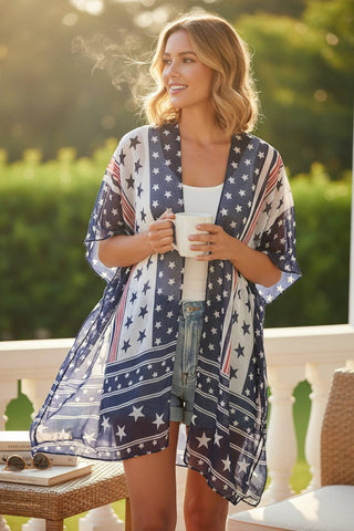 Woman wearing a patriotic kimono holding a cup outdoors.