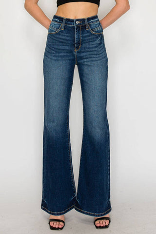 Person wearing blue flared jeans on a white background