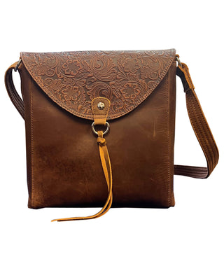 Brown leather bag with embossed design on a white background