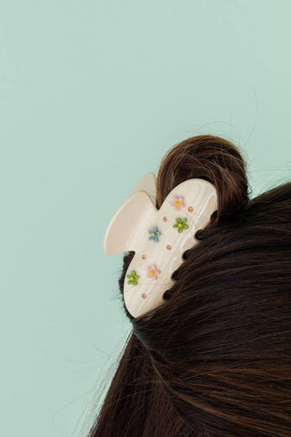 Hair scrunchie with floral design on a light blue background