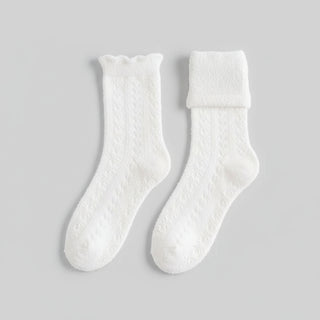 White textured socks on a light gray background