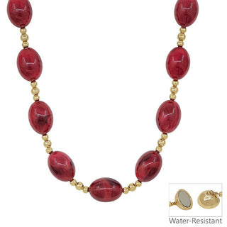 A red and gold beaded necklace with oval red beads separated by small gold beads, shown on a white background with a small inset showing the back of the pendant and the text 'Water-Resistant'.
